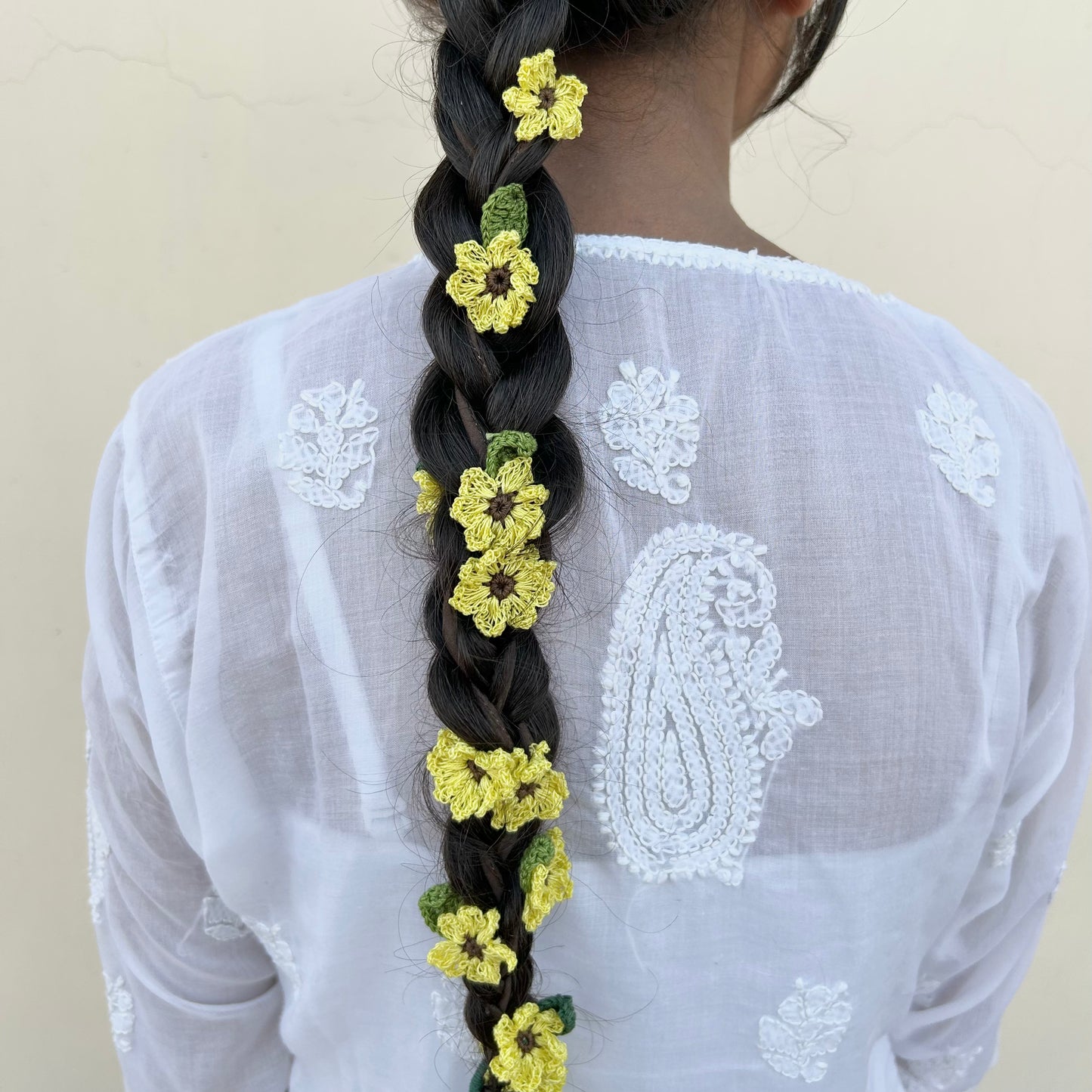 Designed thoughtfully with an eye for detail. Hand crocheted using cotton yarn. Made with care by local women artisans. The parandi can be braided as well as wrapped over a bun or a ponytail too. It can be styled simply with hair down by a hair clip. It is a perfect addition for both Indian as well as Western attire.